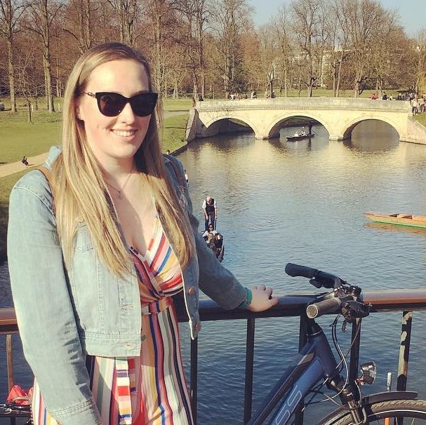Woman stood on bridge in Cambridge smiling