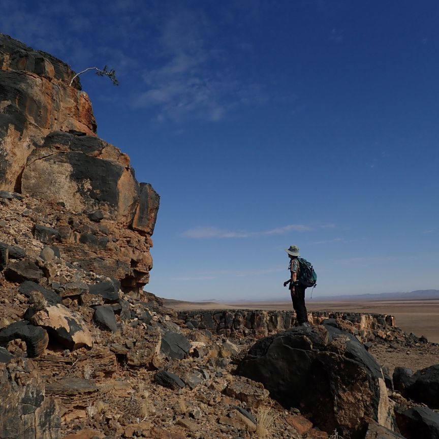 Sedimentologist in the field examining an outcrop