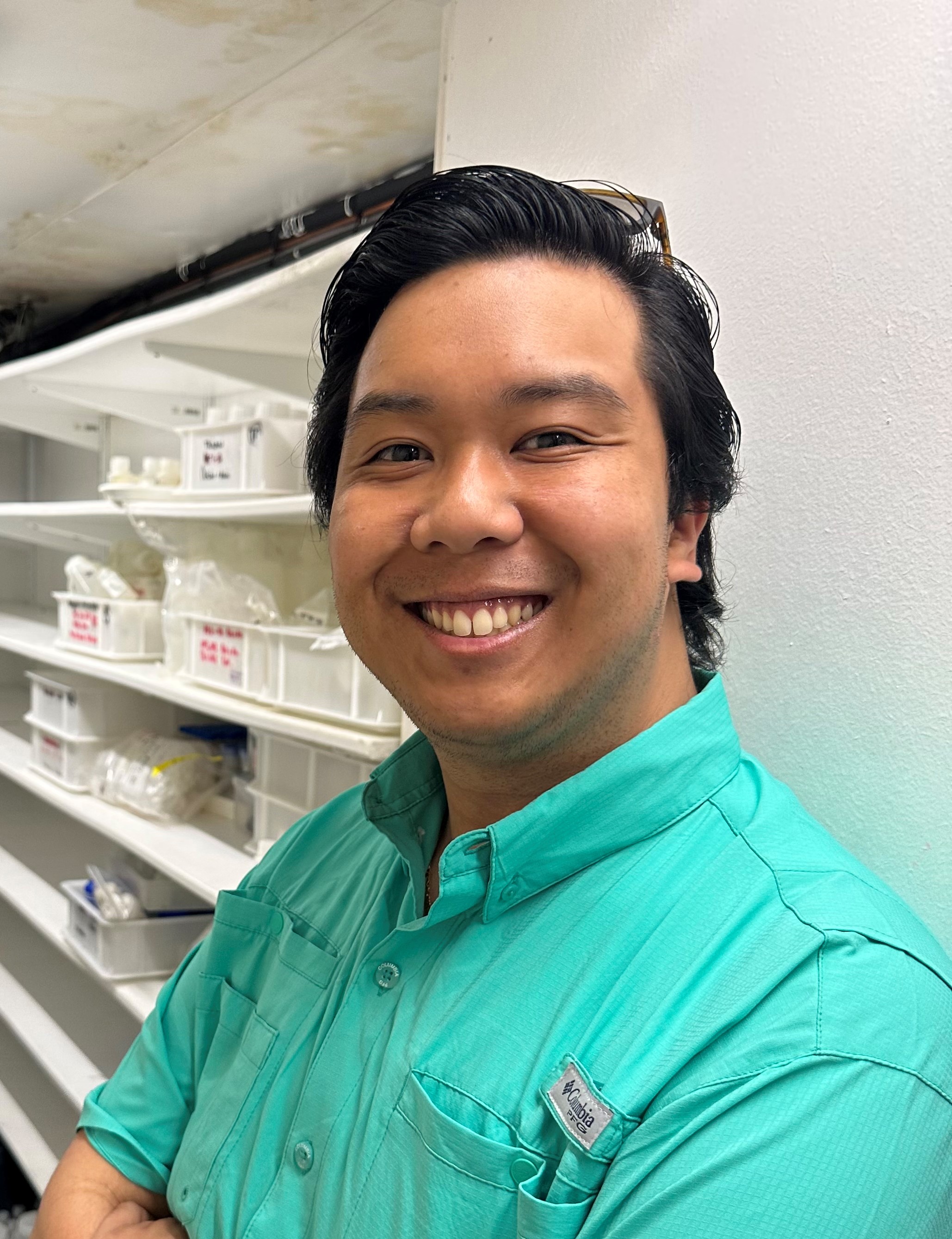 Photo of a Jahmaine stood in the lab smiling.