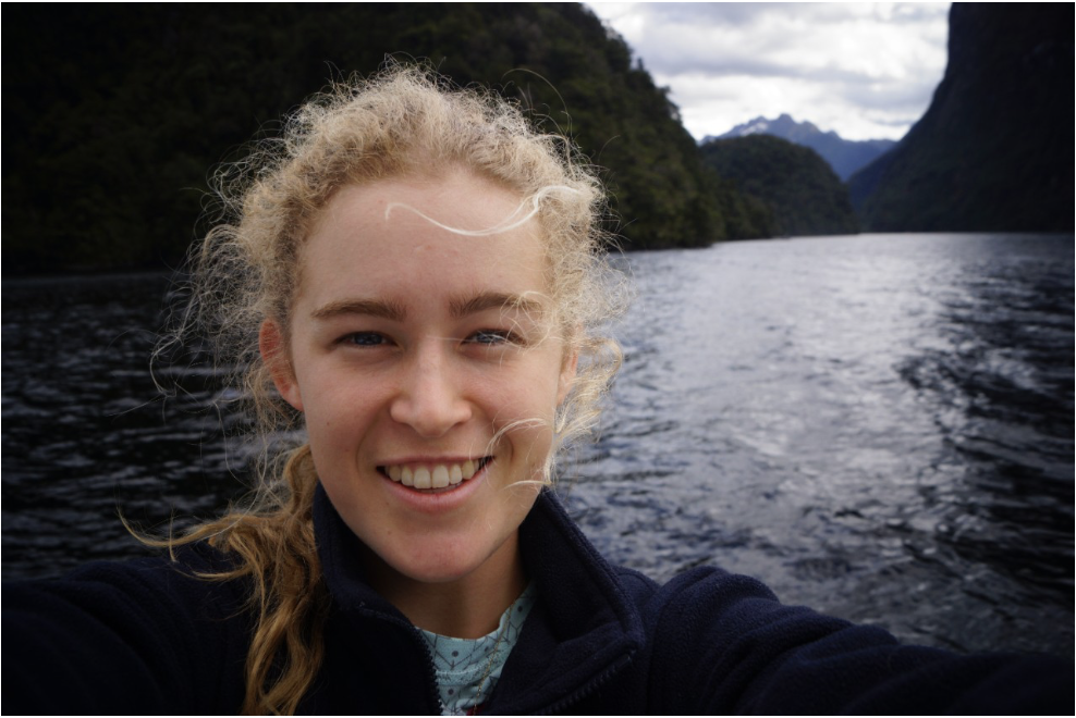 Photo of woman smiling in front of a lake