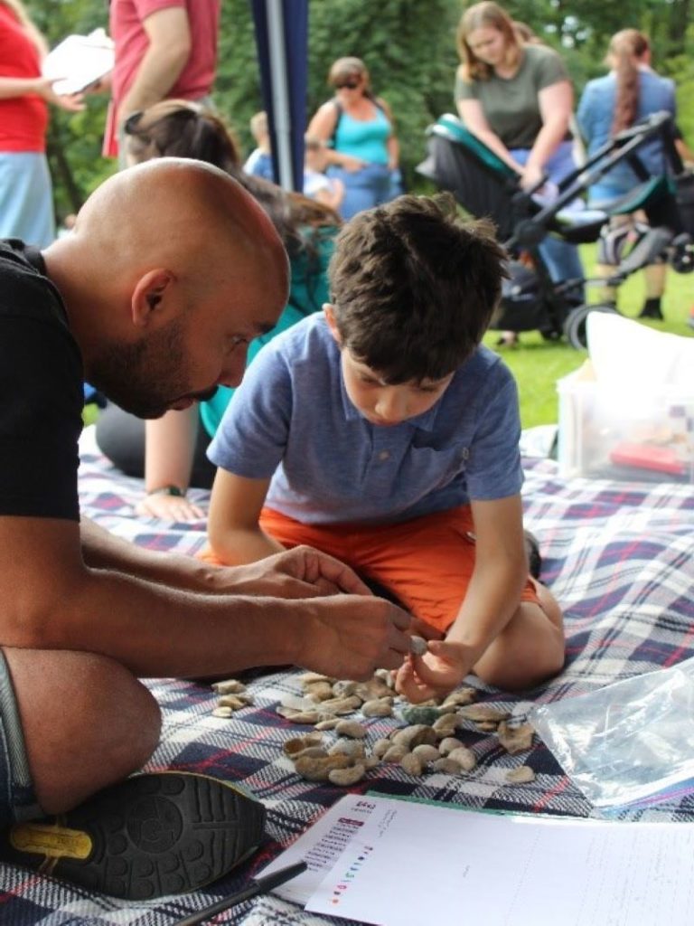 Image showing Rob Theodore working with children from the community on his Community Cabinet project