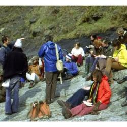 James's year group listen attentively as Bob Jull and Chris Hughes explain Carboniferous geology in Pembrokeshire in 1975. James is in the khaki anorak, next to the student in the yellow jacket.