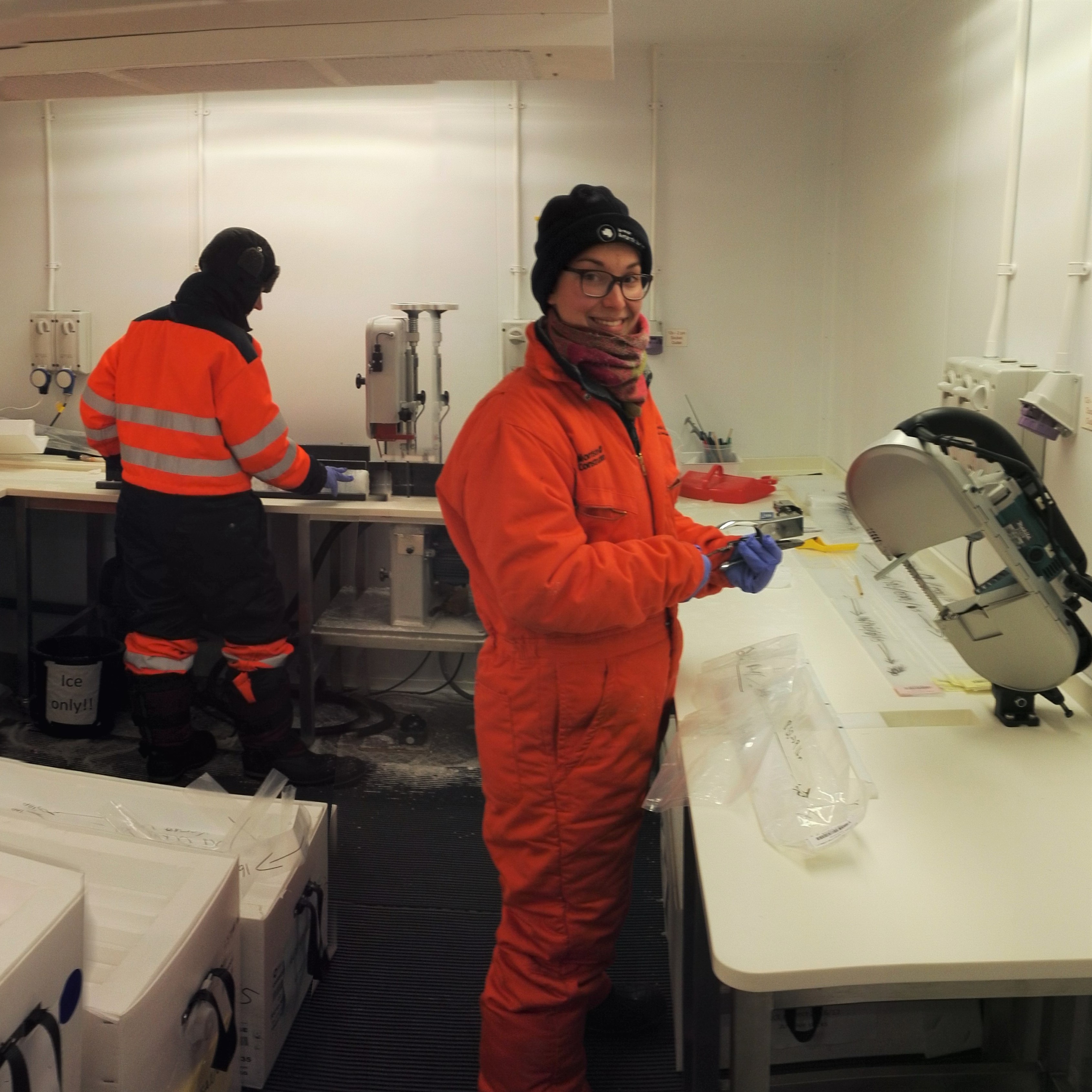 Woman in orange boiler suit working in cold store