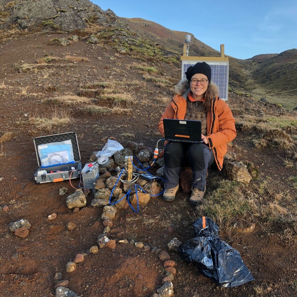 Photos of a person sat by a seismometer smiling