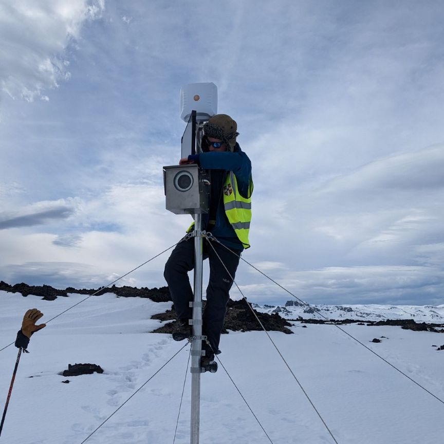 Seismologist setting up monitoring equipment in Iceland