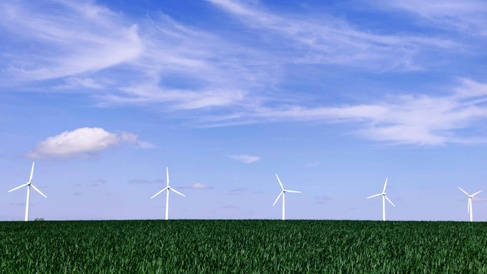 Photo of five wind turbines on the horizon