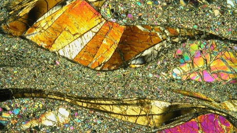 Microphotograph of mantle xenolith, showing large 'wavy' orthopyroxene which has been sheared. 