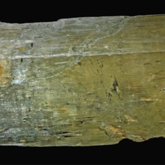 Photo of the mineral spodumene, showing cleavage and inclusions