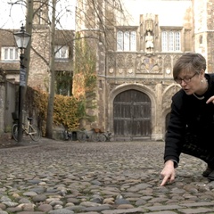 Photo of Professor Holness pointing down at cobbles