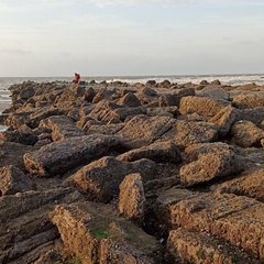 Photo of rocky shore with person in distance