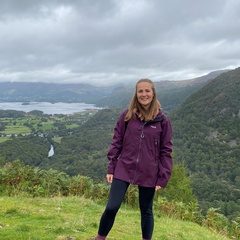 Photo of Natalie Forrest with green hills behind