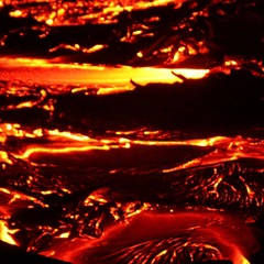 Photo of incandescent lava flow taken at night.