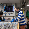 Photo of two men examining cores of rock laid out on a table.