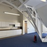 Photo showing kitchen area with metal trusses arcing in the foreground