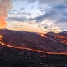 Photo of lava flowing from volcano in evening