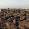 Photo of rocky shore with person in distance