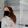 Woman in lab wearing mask