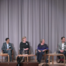Image of group of scientists sat on a stage