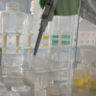 Close up of sample containers and pipette in fume cupboard