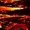 Photo of incandescent lava flow taken at night.