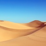 Image of a desert with sand dunes and sunny sky