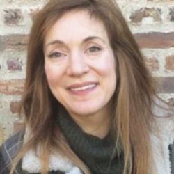 Prof. Helen Williams standing outside Jesus College, Cambridge