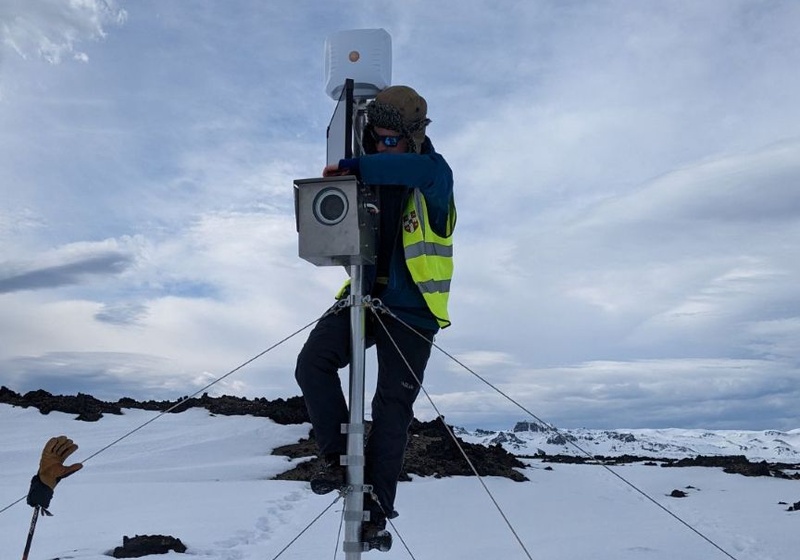 Seismologist setting up monitoring equipment in Iceland