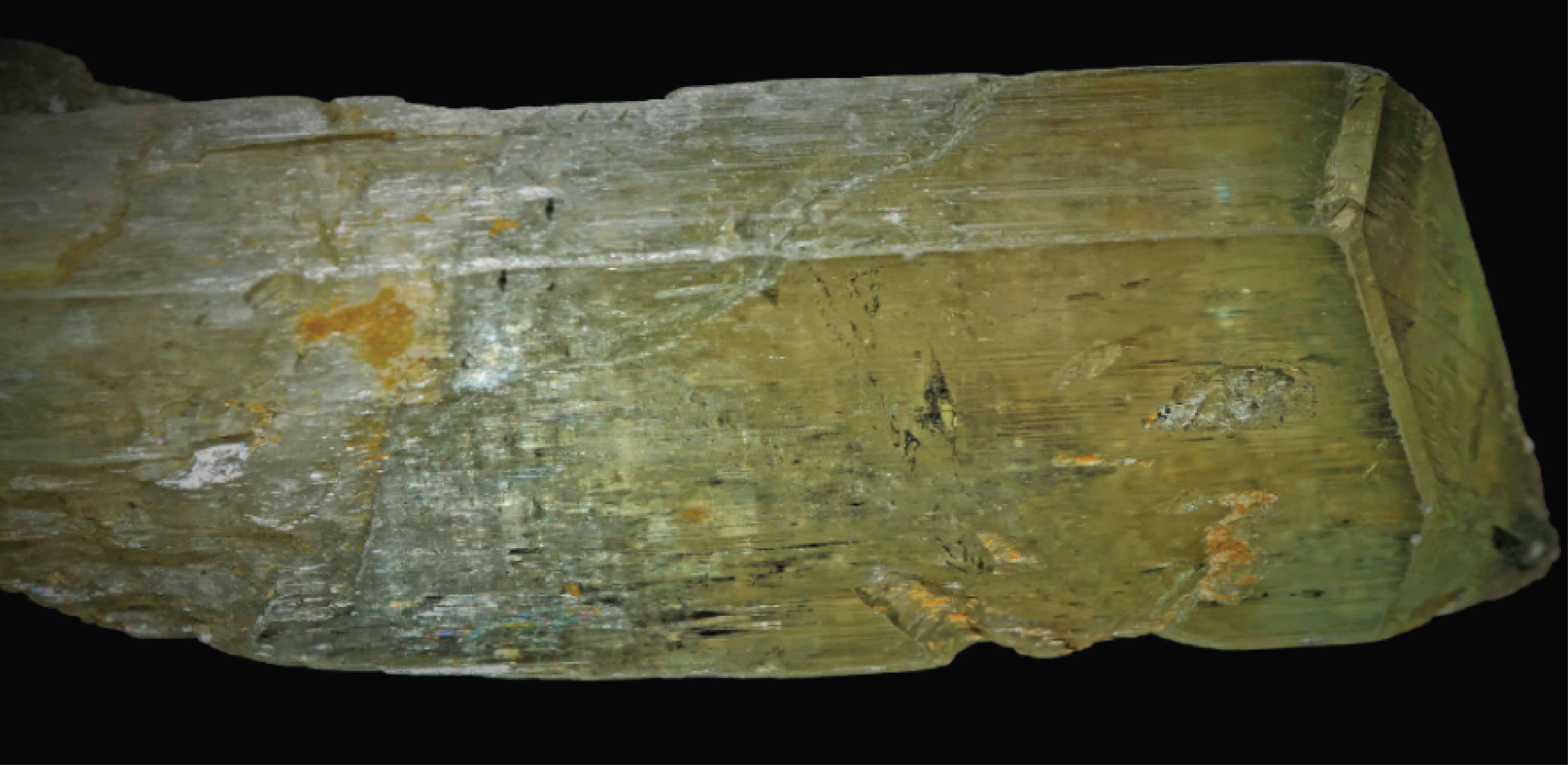 Photo of the mineral spodumene, showing cleavage and inclusions