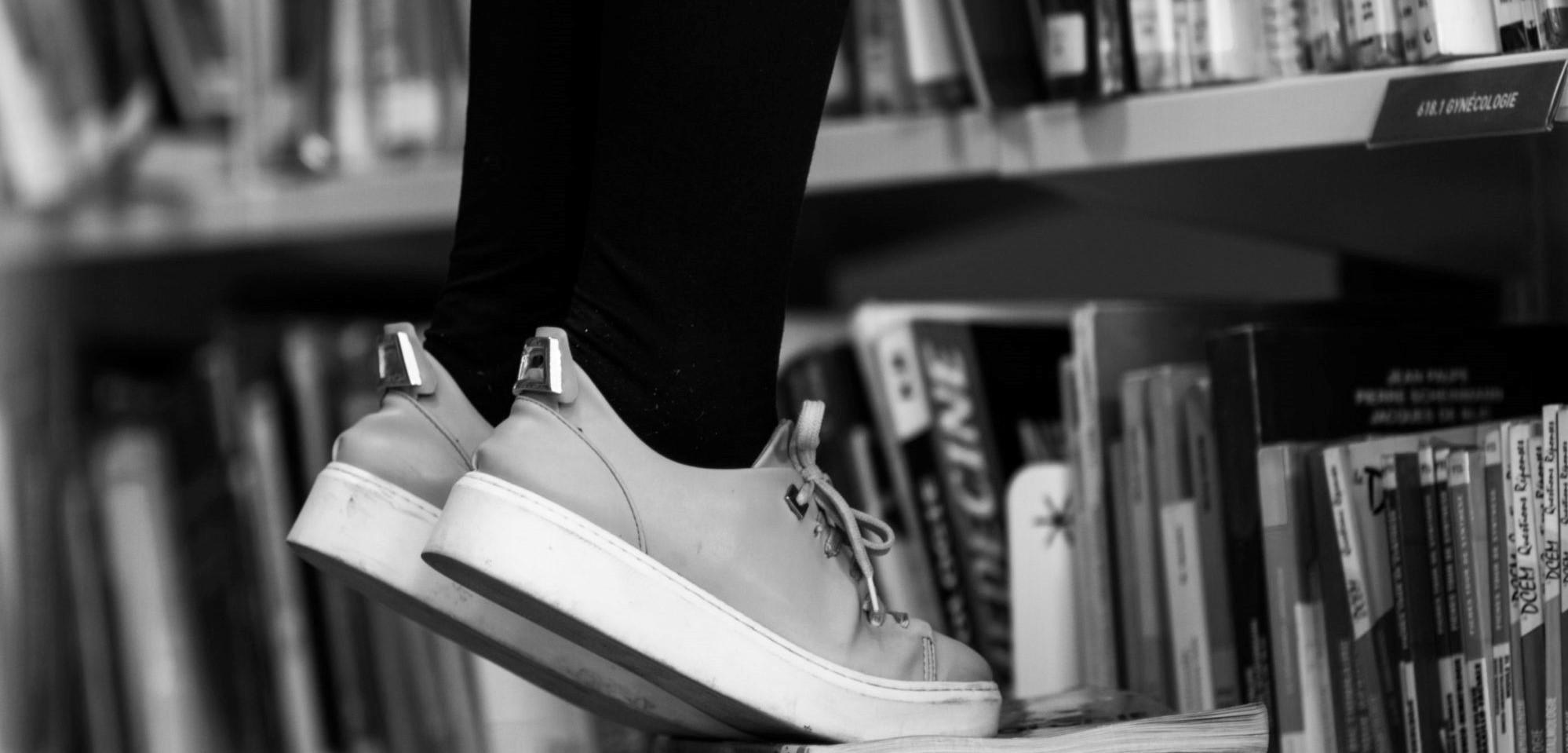 Photo of stool reaching books in library