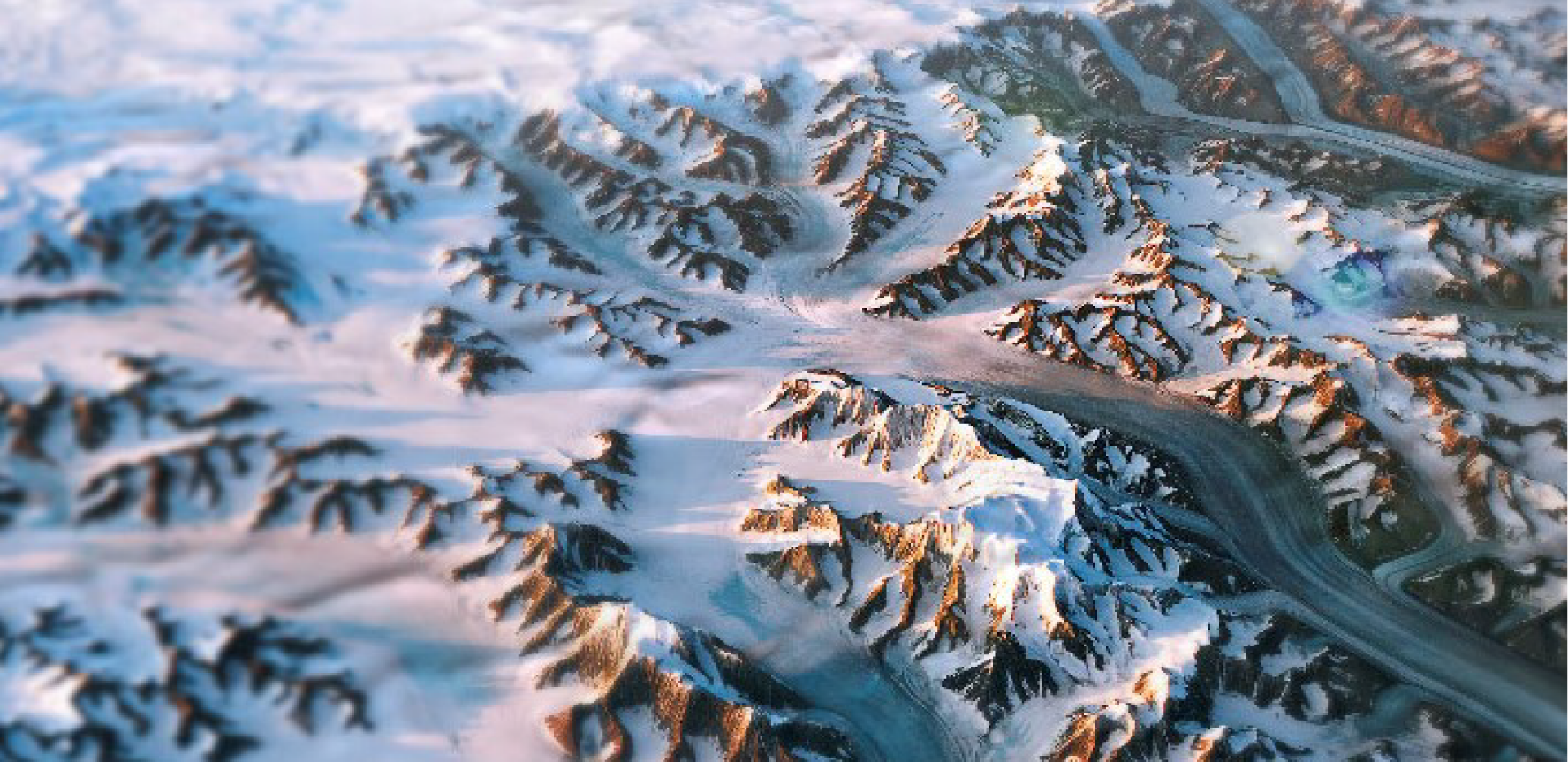 Greenland, NASA Earth Observatory Birds eye image of Greenland glacier flowing through a snowing mountainous landscape