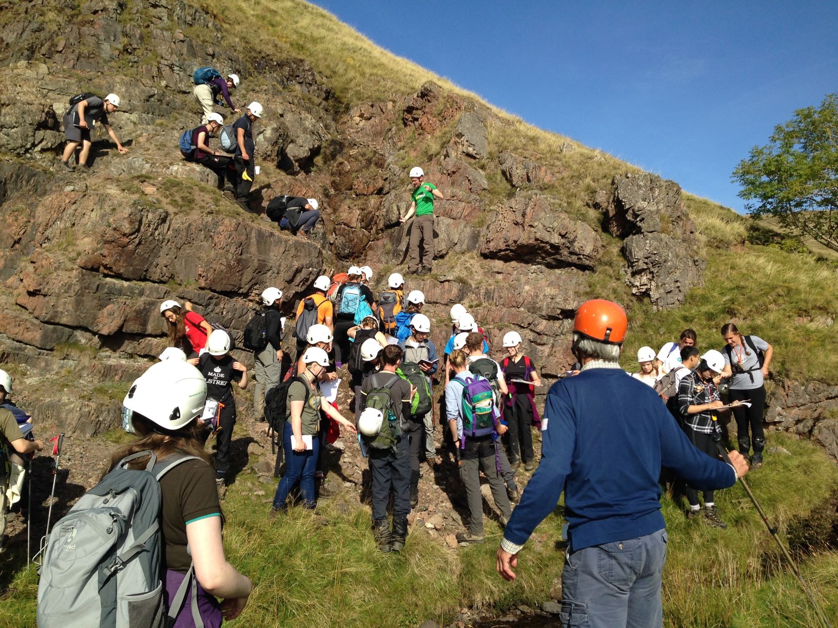 A Cambridge student party examines volcanic rocks in the Ordovician part of the Backside Beck section in 2016