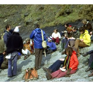 James's year group listen attentively as Bob Jull and Chris Hughes explain Carboniferous geology in Pembrokeshire in 1975. James is in the khaki anorak, next to the student in the yellow jacket.