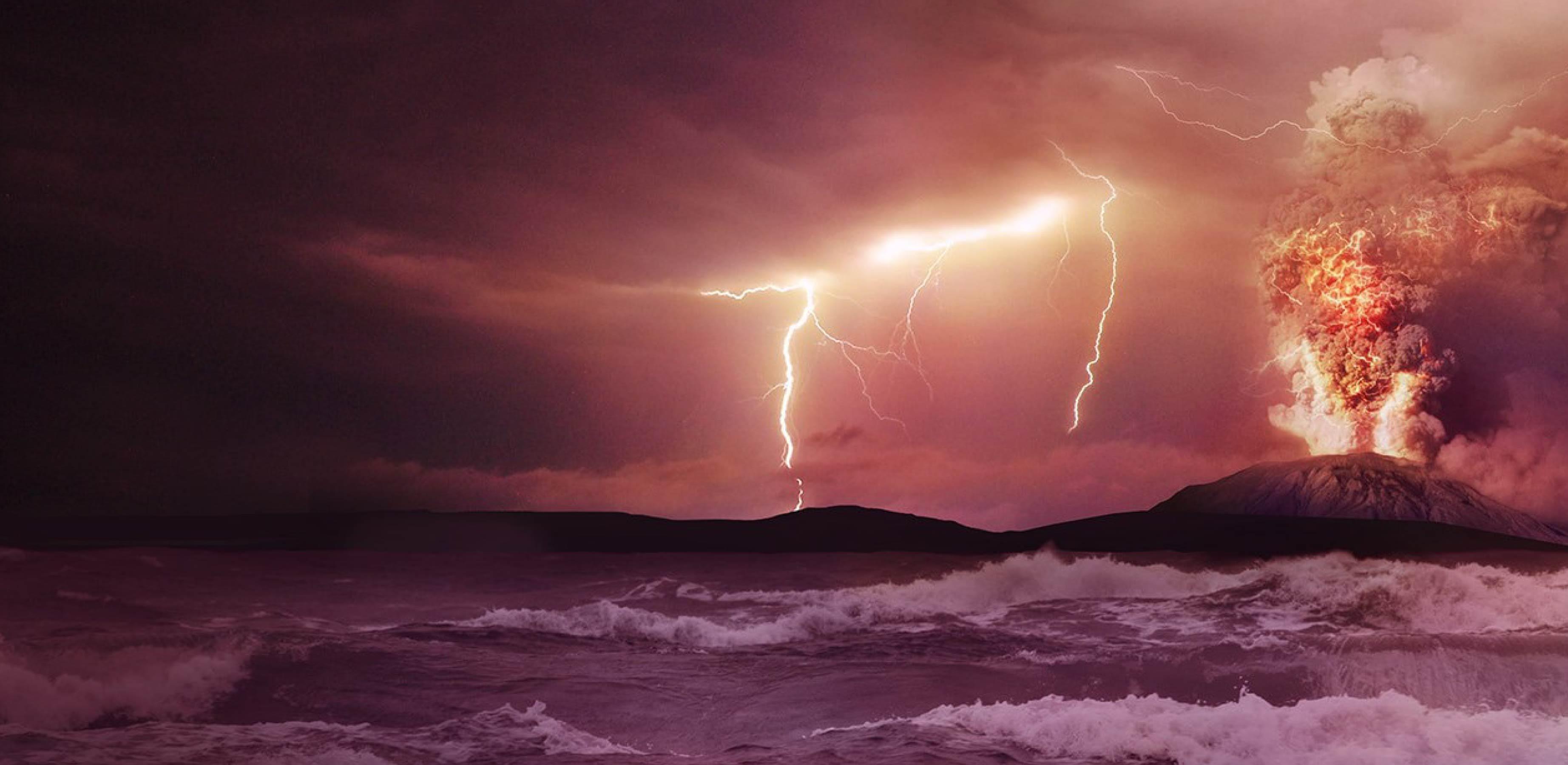 Photo of volcanic eruption with lightning and stormy sea in foreground