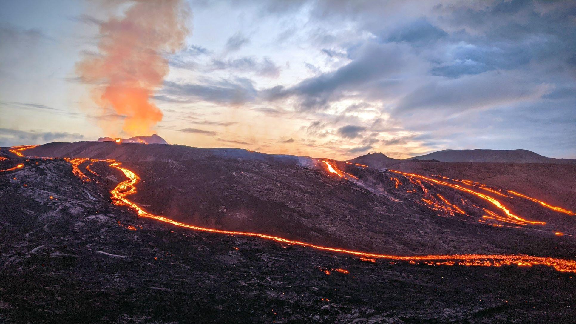 Photo of lava flowing from volcano in evening