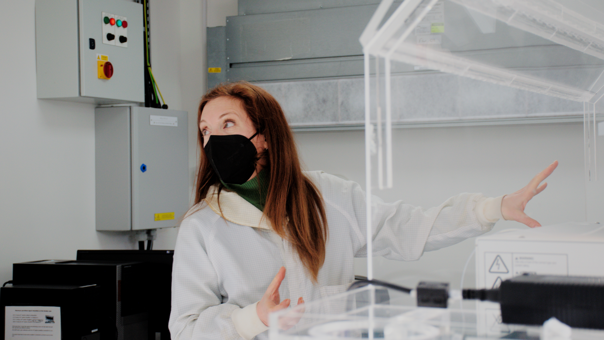 Woman in lab wearing mask