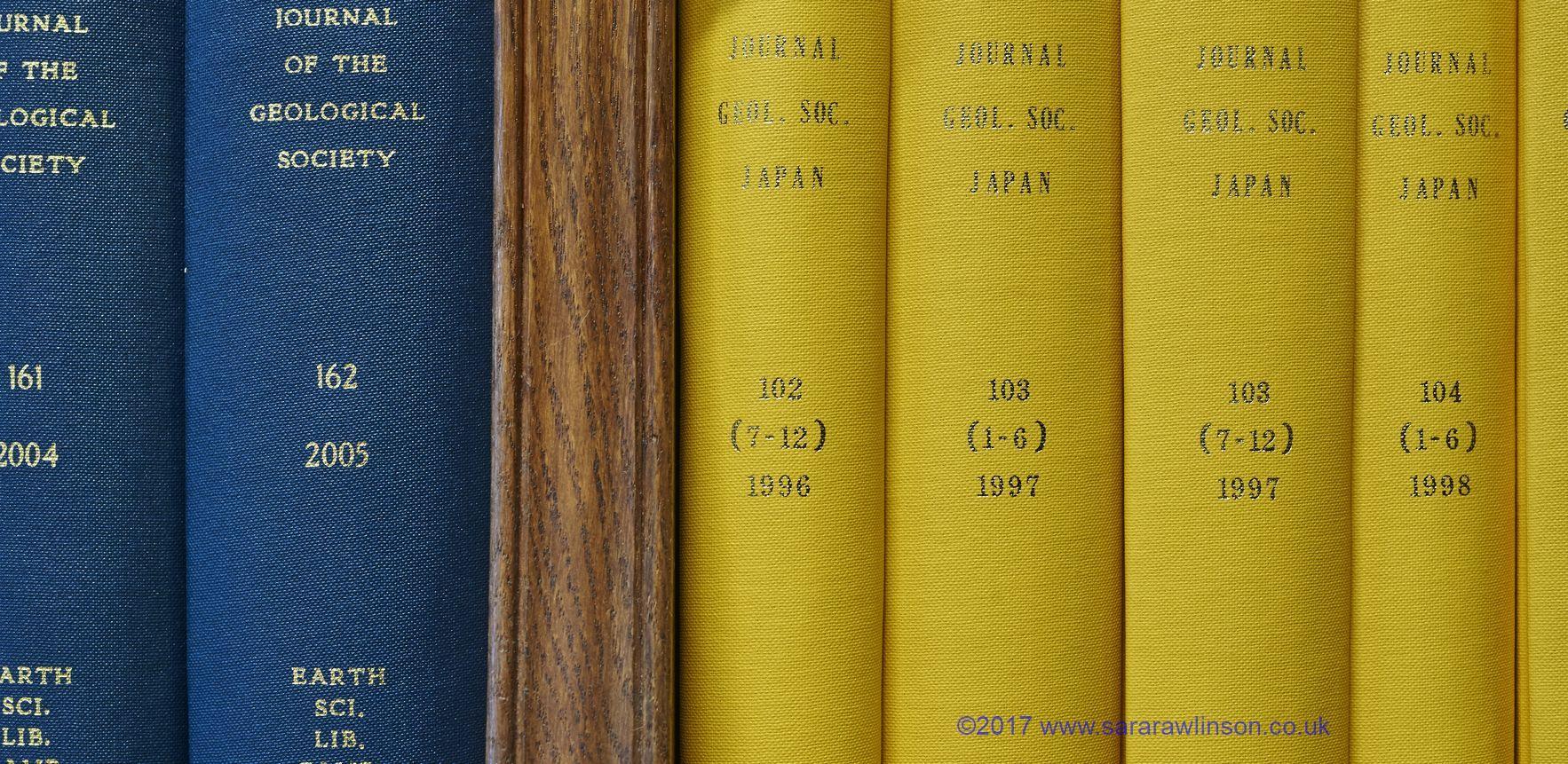 Yellow and blue journal covers on the library shelves; image credit Rawlinson copyright
