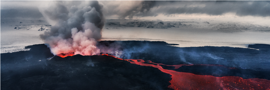 Image showing ash spewing out of a volcano, with ice covered landscape behind and incandescent lava flow in the foreground